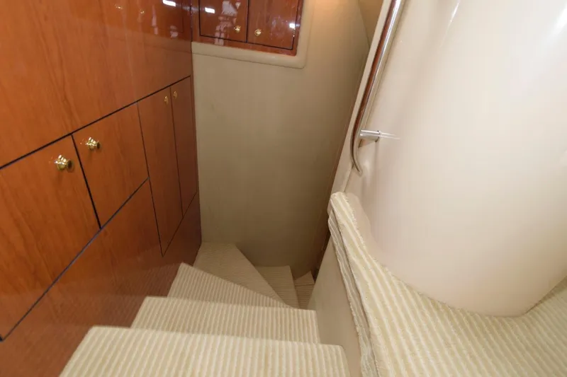 Slide: The Image of Staircase inside 2001 Sea Ray 540 Cockpit Motor Yacht with wooden cabinets and carpeted steps. - 32