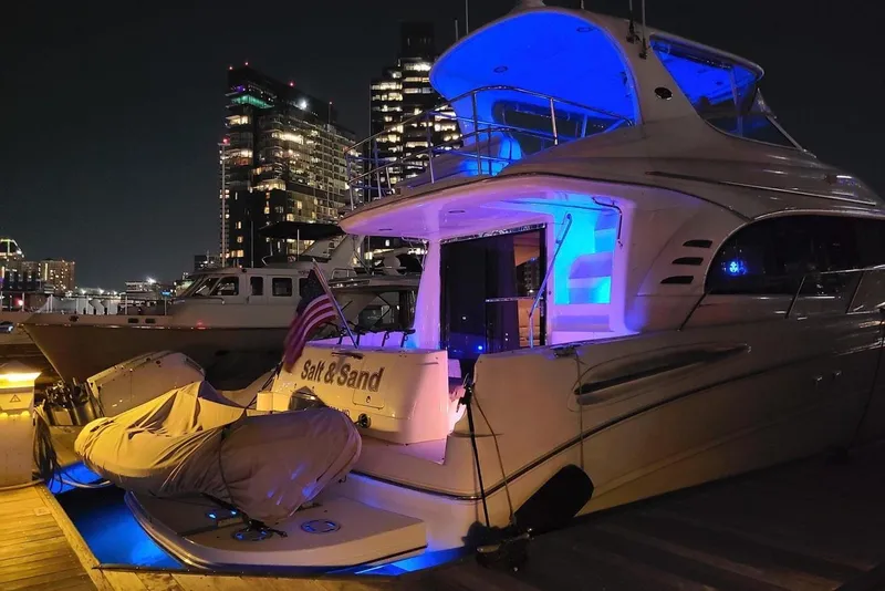 Slide: The Image of 2001 Sea Ray 540 Cockpit Motor Yacht docked at night with city skyline. - 4