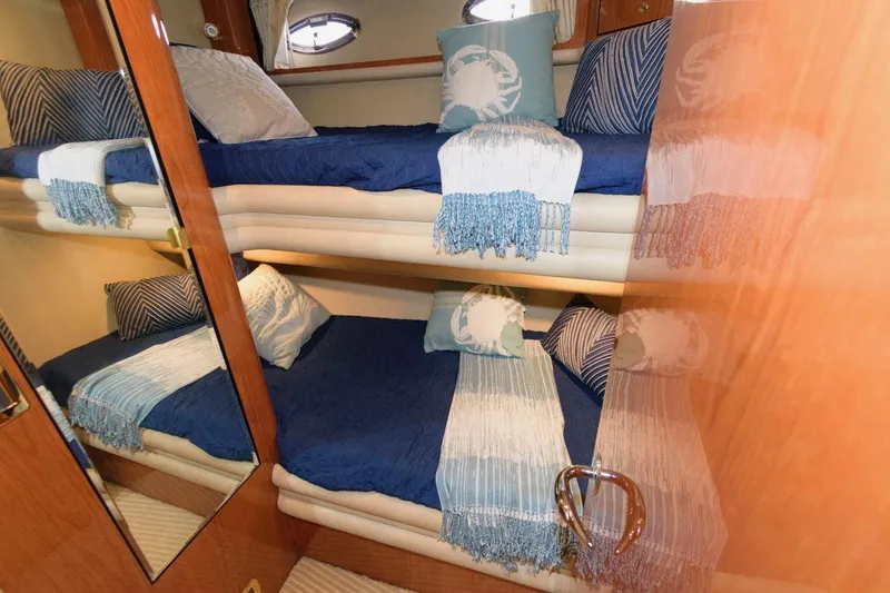 Slide: The Image of Bunk beds in 2001 Sea Ray 540 Cockpit Motor Yacht cabin, featuring blue and white decor. - 40