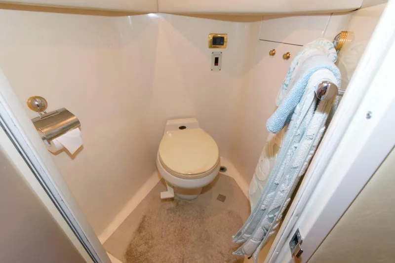 Slide: The Image of 2001 Sea Ray 540 Cockpit Motor Yacht bathroom with toilet and towels. - 41