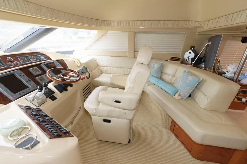 Slide: The Image of Luxurious interior of 2001 Sea Ray 540 Cockpit Motor Yacht with plush seating and helm. - 51