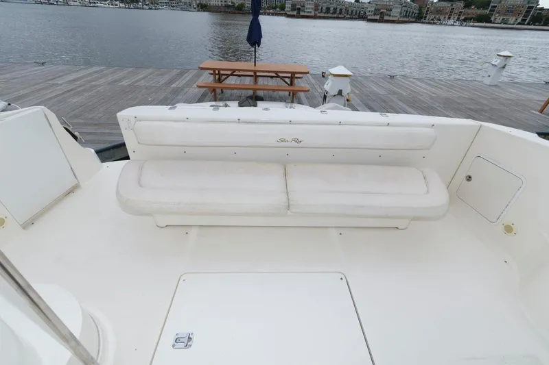 Slide: The Image of 2001 Sea Ray 540 Cockpit Motor Yacht with white seating, dockside view. - 7