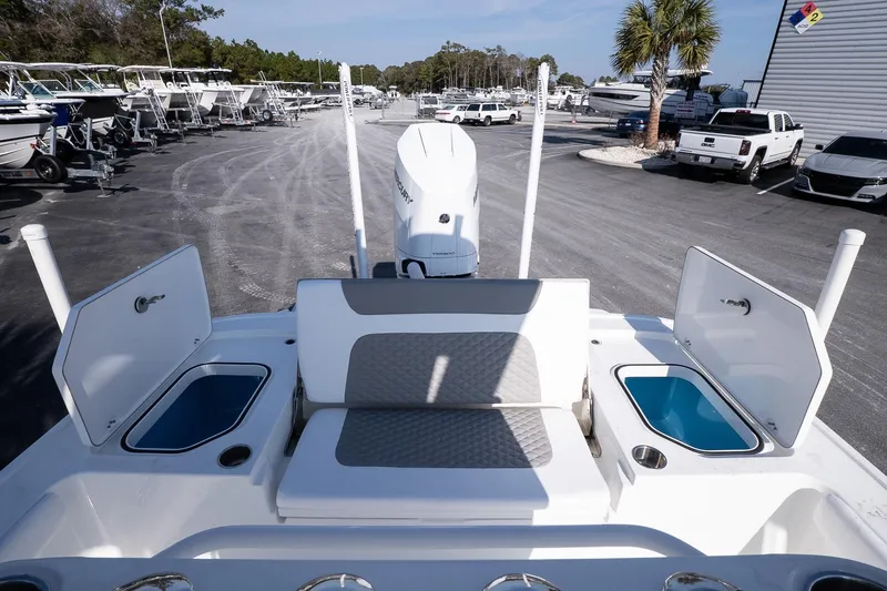 Slide: The Image of 2026 Caymas 28 HB boat interior with seating and storage compartments in a marina setting. - 10