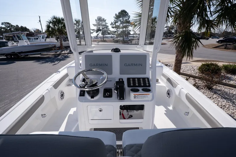 Slide: The Image of 2026 Caymas 28 HB boat cockpit with Garmin navigation system and sleek steering wheel. - 11