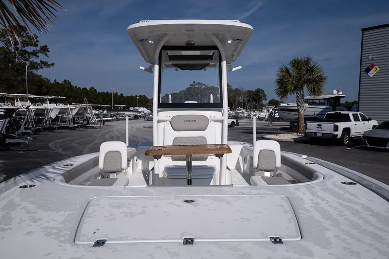 Slide: The Image of 2026 Caymas 28 HB boat in marina, featuring center console and seating. - 16