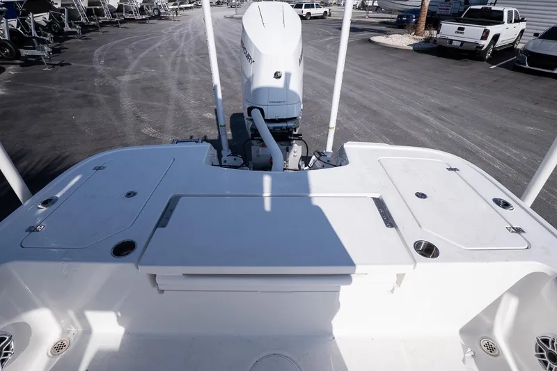 Slide: The Image of 2026 Caymas 28 HB boat deck with Mercury engine, parked in a marina. - 9