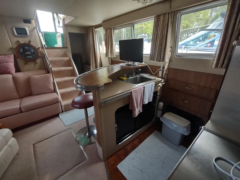 Slide: The Image of Interior of 1987 Chris-Craft 381 Catalina yacht with kitchen and seating area. - 16
