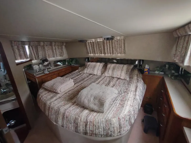 Slide: The Image of Interior of 1987 Chris-Craft 381 Catalina yacht featuring cozy bedroom. - 26