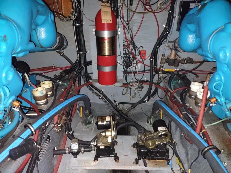 Slide: The Image of Engine room of a 1987 Chris-Craft 381 Catalina boat with blue engines. - 31