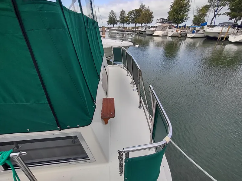 Slide: The Image of 1987 Chris-Craft 381 Catalina yacht docked with green cover. - 5