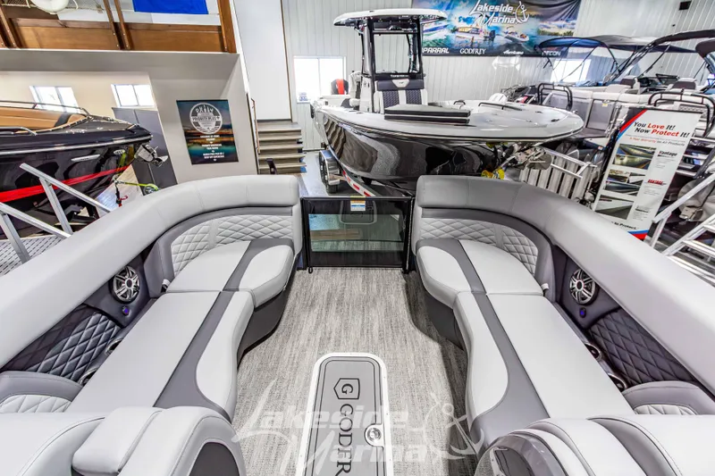 Slide: The Image of Luxurious 2026 Godfrey Monaco 255 MTF pontoon boat interior with plush seating and modern design. - 12