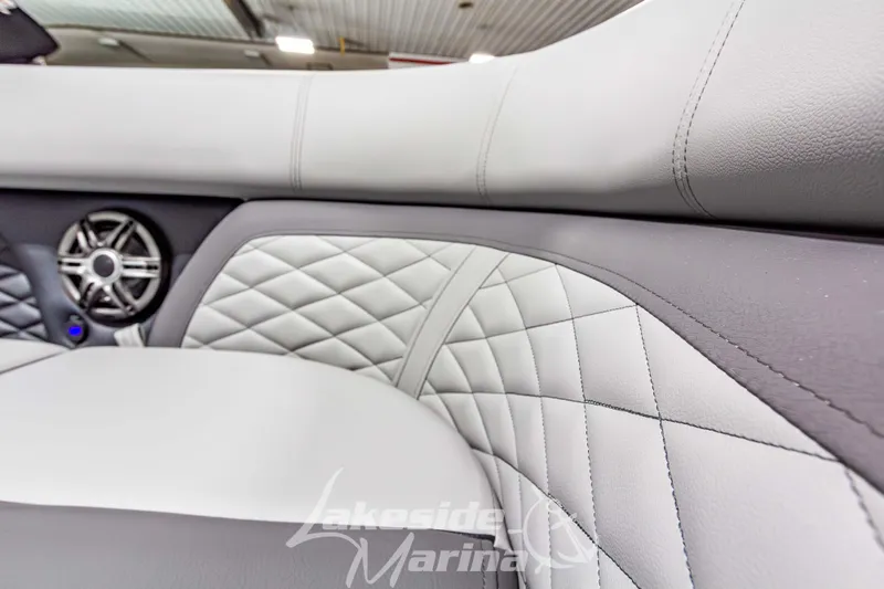 Slide: The Image of Luxurious interior of 2026 Godfrey Monaco 255 MTF boat with quilted upholstery and speaker. - 14