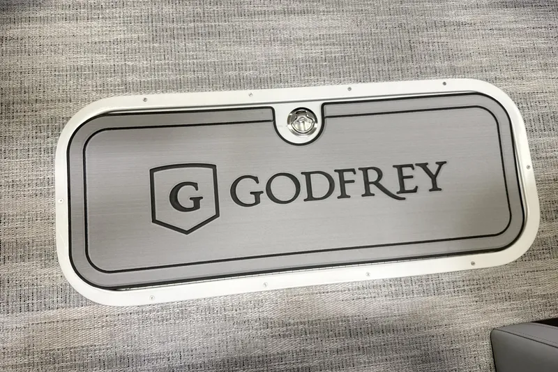 Slide: The Image of 2026 Godfrey Monaco 255 MTF pontoon boat displayed indoors at a showroom. - 3