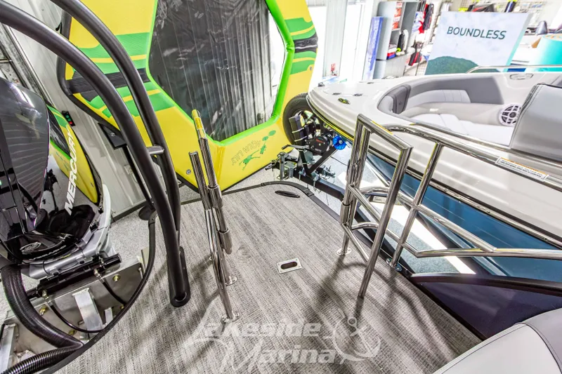 Slide: The Image of 2026 Godfrey Monaco 255 MTF boat interior with Mercury engine and vibrant green accents. - 44