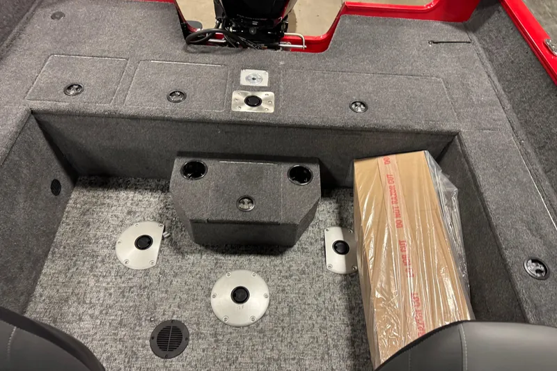 Slide: The Image of Interior of 2026 Tracker Pro Guide V-175 WT boat with carpeted flooring and storage compartments. - 14