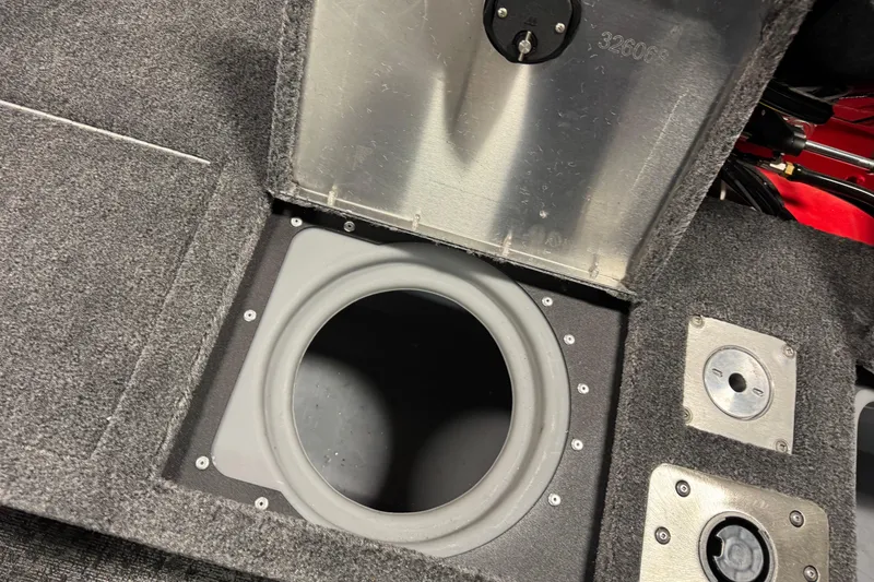 Slide: The Image of 2026 Tracker Pro Guide V-175 WT boat storage compartment with open hatch and carpeted interior. - 16