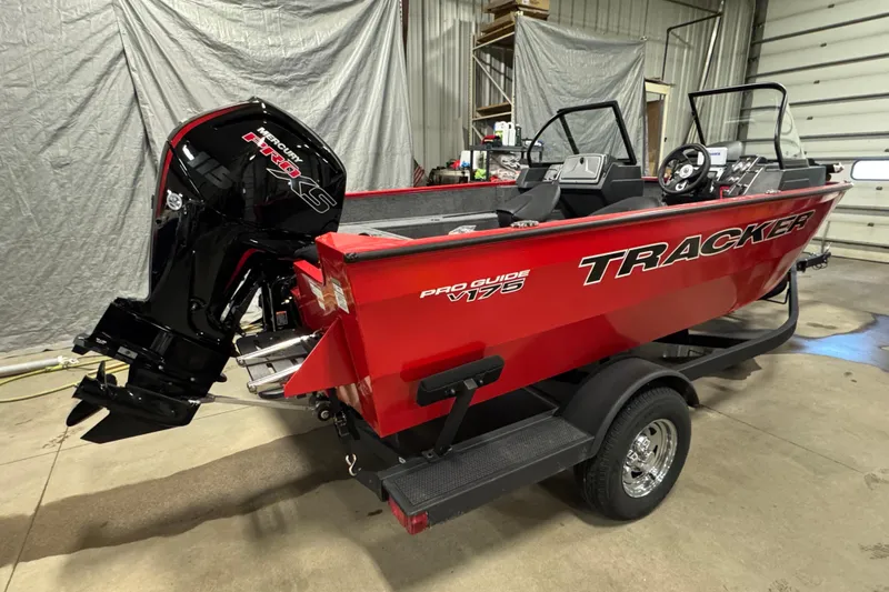 Slide: The Image of 2026 Tracker Pro Guide V-175 WT boat in a garage, featuring a powerful Mercury engine. - 4
