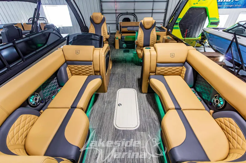 Slide: The Image of Luxurious interior of 2026 Godfrey Monaco 255 MTF pontoon boat with tan leather seating. - 11