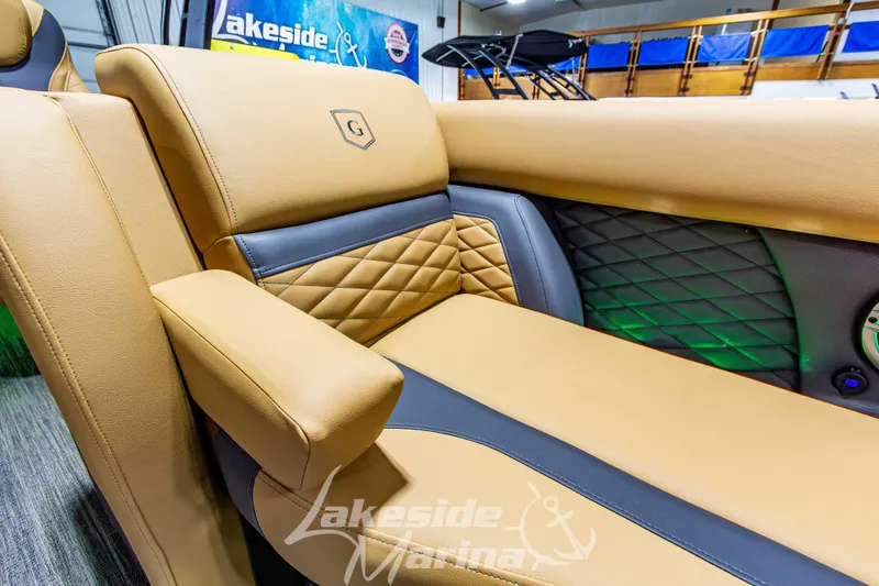 Slide: The Image of Luxurious seating on 2026 Godfrey Monaco 255 MTF boat, featuring tan and gray upholstery. - 16
