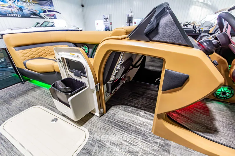 Slide: The Image of Interior of 2026 Godfrey Monaco 255 MTF boat with tan seating and storage compartment. - 21