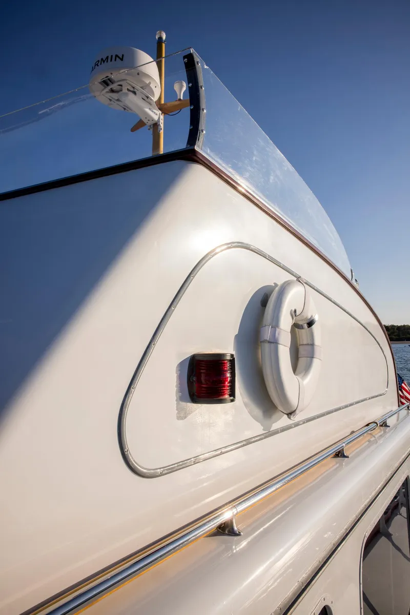 Slide: The Image of 1964 Huckins Out Islander 56 yacht, featuring sleek design and safety equipment. - 13