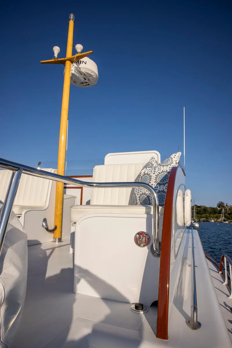 Slide: The Image of 1964 Huckins Out Islander 56 yacht deck with seating and clear blue sky. - 14
