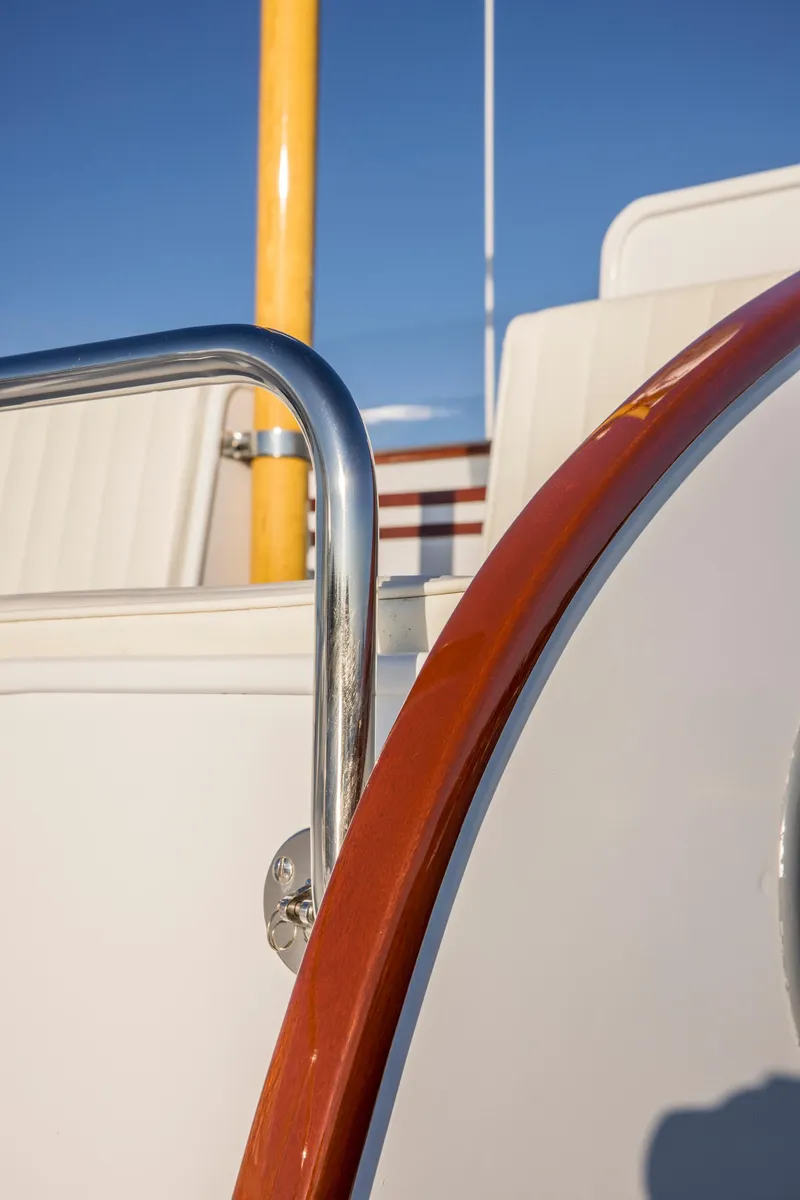 Slide: The Image of 1964 Huckins Out Islander 56 yacht detail with polished metal and wood accents. - 15