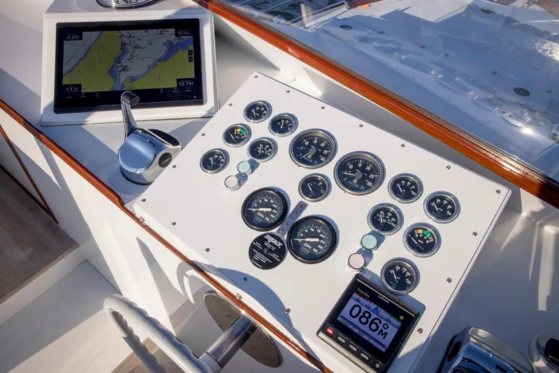 Slide: The Image of 1964 Huckins Out Islander 56 yacht dashboard with navigation instruments and controls. - 27
