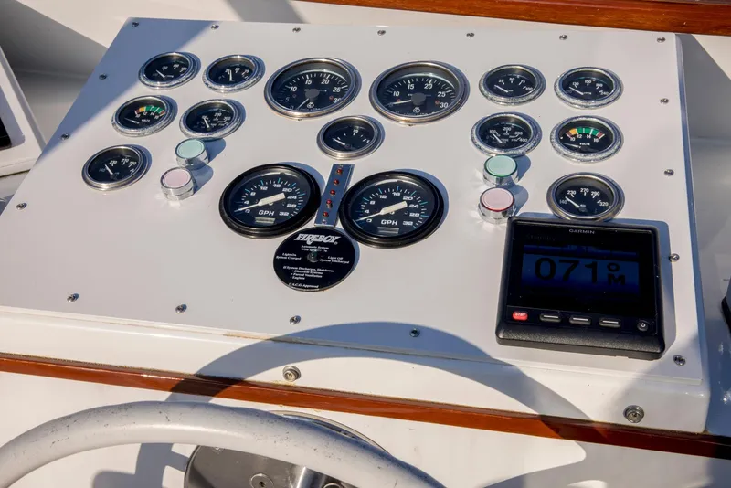 Slide: The Image of Control panel of a 1964 Huckins Out Islander 56 yacht with gauges and digital display. - 28
