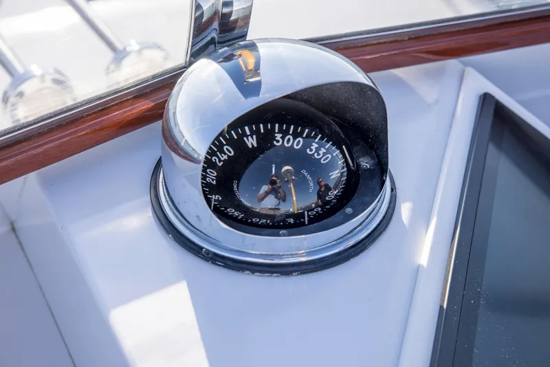 Slide: The Image of Compass on 1964 Huckins Out Islander 56 yacht, showing navigation details. - 29