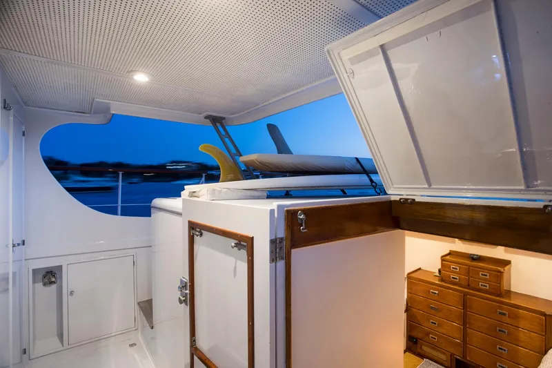 Slide: The Image of 1964 Huckins Out Islander 56 yacht interior with surfboards and wooden storage cabinets. - 31
