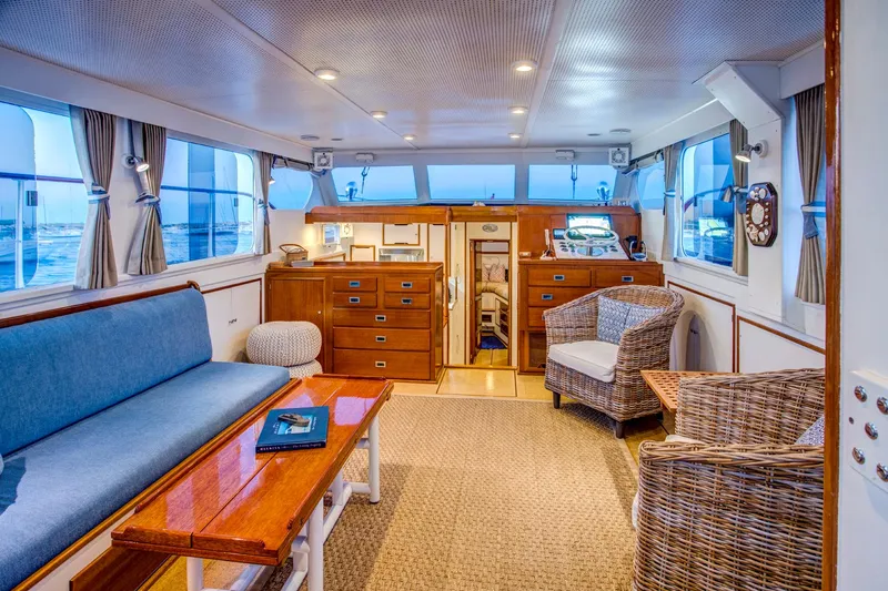Slide: The Image of Interior of 1964 Huckins Out Islander 56 yacht with elegant wood furnishings and seating. - 32