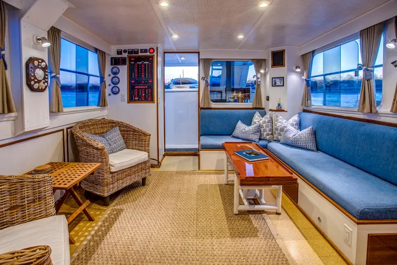 Slide: The Image of Interior of 1964 Huckins Out Islander 56 yacht with cozy seating and nautical decor. - 33