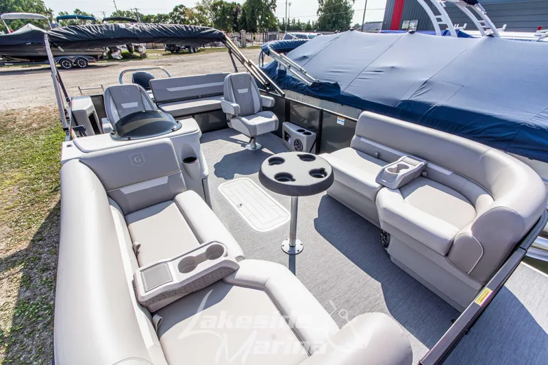 Slide: The Image of 2026 Godfrey Sweetwater 2286 SFLX pontoon boat interior with plush seating and table. - 10