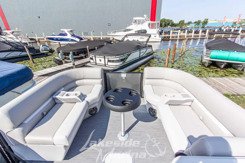 Slide: The Image of 2026 Godfrey Sweetwater 2286 SFLX pontoon boat interior at marina dock. - 12