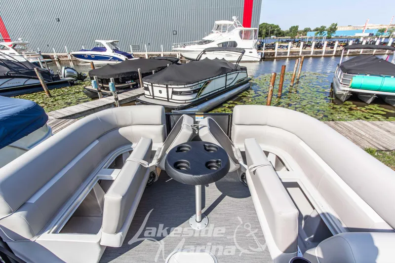 Slide: The Image of 2026 Godfrey Sweetwater 2286 SFLX pontoon boat with spacious seating at marina dock. - 14