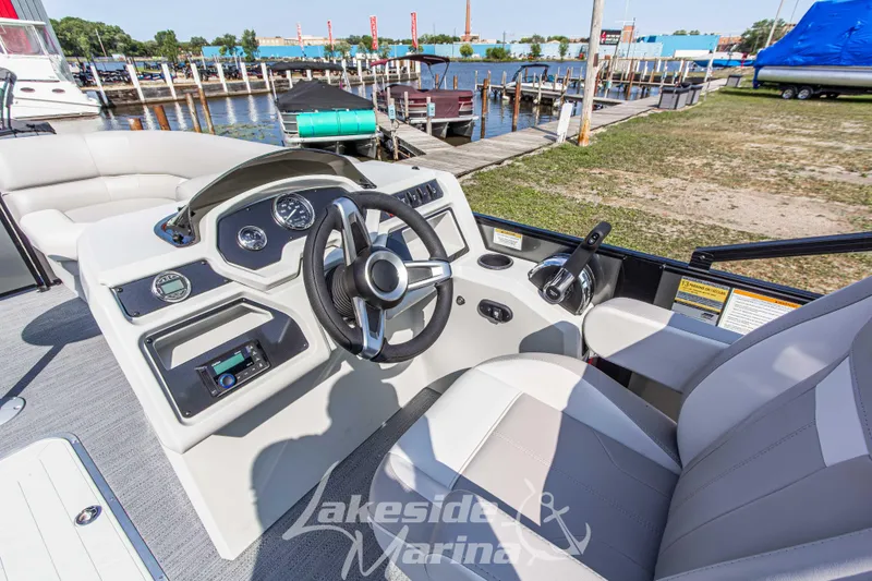 Slide: The Image of 2026 Godfrey Sweetwater 2286 SFLX boat interior with steering wheel and dashboard controls. - 18