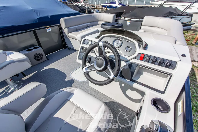Slide: The Image of 2026 Godfrey Sweetwater 2286 SFLX boat interior with steering wheel and seating. - 19