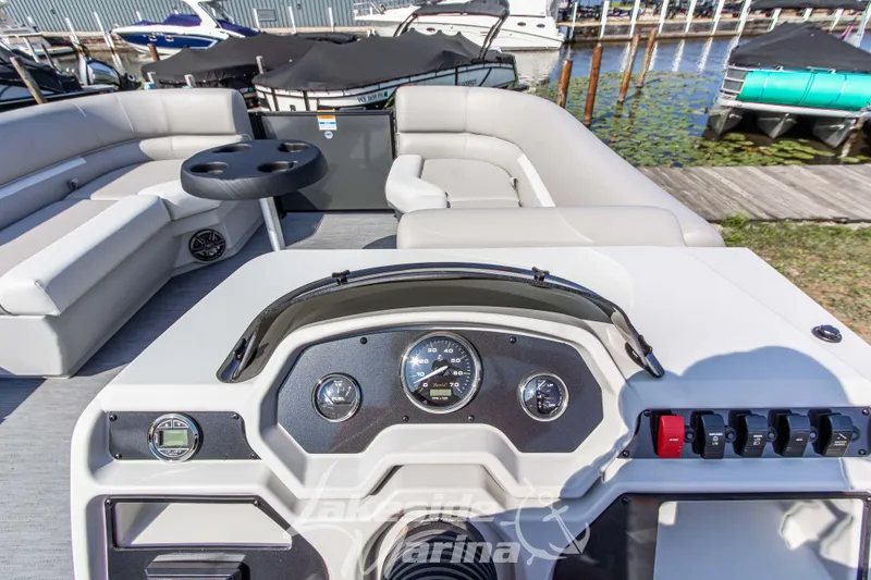 Slide: The Image of 2026 Godfrey Sweetwater 2286 SFLX pontoon boat interior with dashboard and seating. - 20