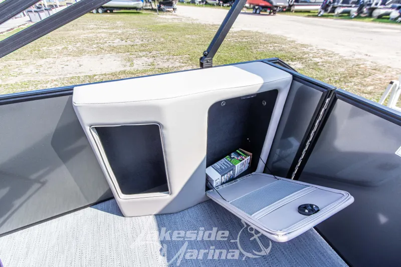 Slide: The Image of Interior storage compartment of 2026 Godfrey Sweetwater 2286 SFLX boat, open with items inside. - 26