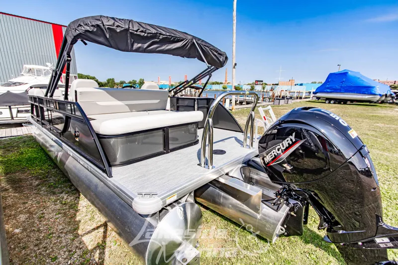 Slide: The Image of 2026 Godfrey Sweetwater 2286 SFLX pontoon boat with Mercury engine, docked outdoors. - 8