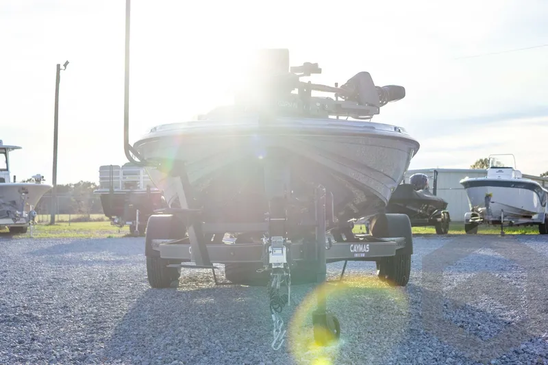 Slide: The Image of 2026 Caymas CX 21 PRO boat on trailer, sunlit background, gravel lot. - 10