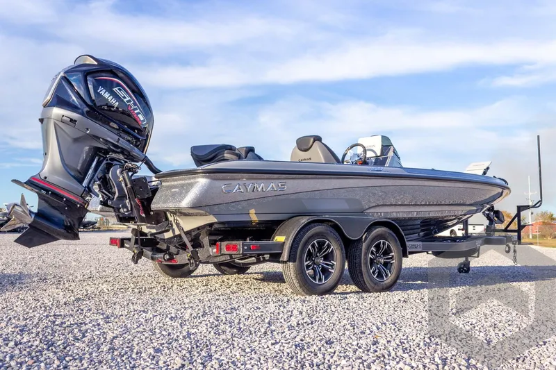 Slide: The Image of 2026 Caymas CX 21 PRO boat with Yamaha engine on a trailer, parked on gravel. - 13