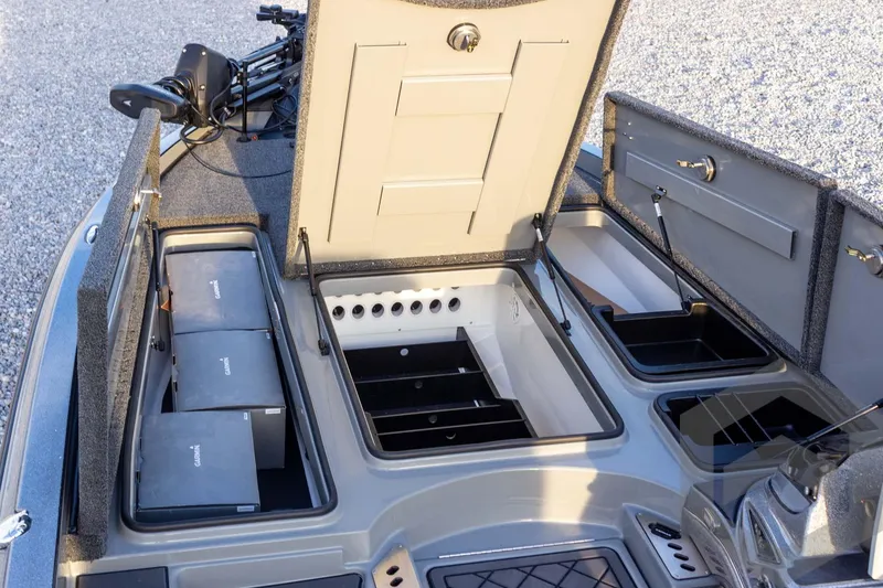 Slide: The Image of 2026 Caymas CX 21 PRO boat storage compartments with open lids, showcasing organized interior. - 28