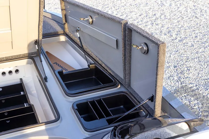 Slide: The Image of 2026 Caymas CX 21 PRO boat storage compartments with open lids and organized trays. - 29