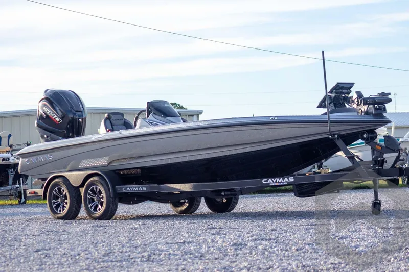 Slide: The Image of 2026 Caymas CX 21 PRO boat on trailer, featuring sleek design and dual engines. - 4