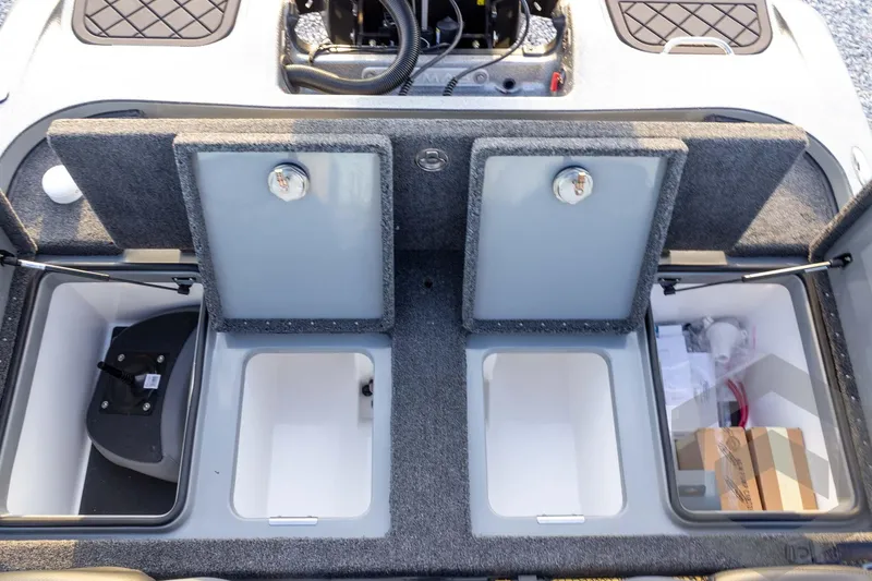 Slide: The Image of 2026 Caymas CX 21 PRO boat storage compartments with open lids and organized interior. - 49