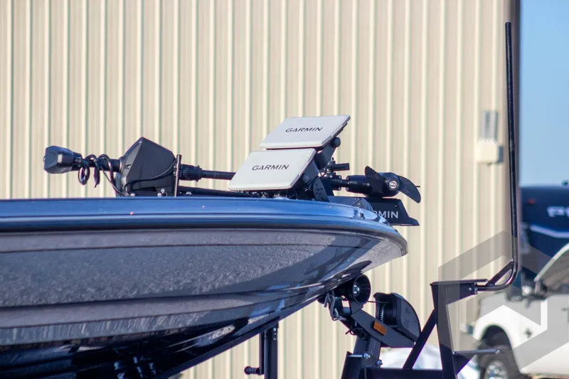Slide: The Image of 2026 Caymas CX 21 PRO boat with Garmin electronics, docked near a building. - 7