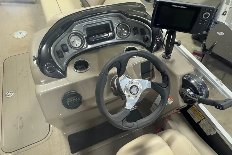 Slide: The Image of 2020 Sun Tracker SportFish 22 XP3 boat dashboard with steering wheel and navigation system. - 11