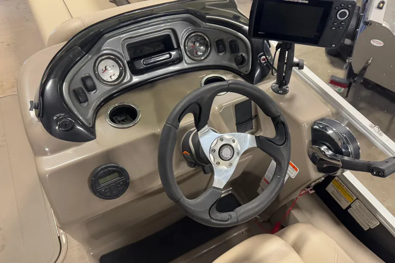 Slide: The Image of 2020 Sun Tracker SportFish 22 XP3 dashboard with steering wheel and control panel. - 13